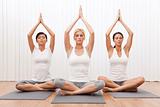 Interracial Group of Three Beautiful Women In Yoga Position