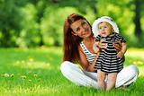 Mother and daughter on the green grass