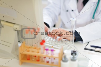 Closeup on hands of medical doctor working on pc