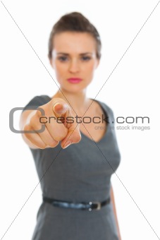Business woman pointing on you. Focus on finger