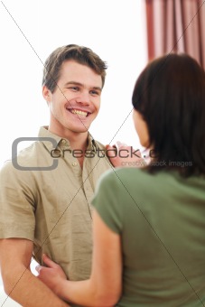 Cheerful couple in love enjoying themselves at home
