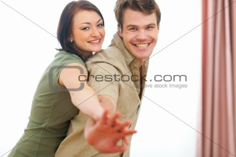 Smiling young couple having fun at home