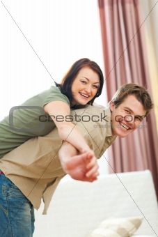 Smiling young couple in love enjoying themselves at home