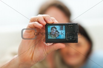 Closeup on camera making portrait of young couple