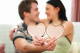 Closeup on Valentines hearts in hands of romantic couple
