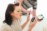Guy trying to hurry up girlfriend applying make-up