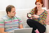 Red hair young woman hinting to boyfriend it's time to spend time with her