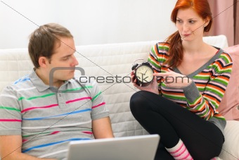 Red hair young woman hinting to boyfriend it's time to spend time with her