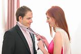 Red hair young woman helping tie necktie
