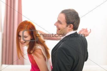 Formally dressed cheerful couple having fun dancing