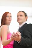 Closeup on hands of formally dressed dancing couple