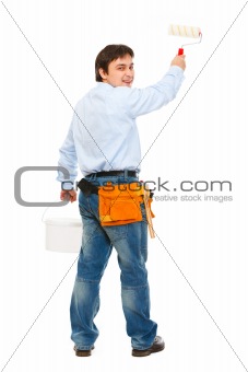 Construction worker with bucket and brush painting