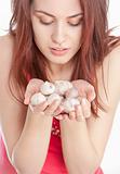 Young woman holding garlic in her hands
