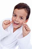 Little boy flossing teeth