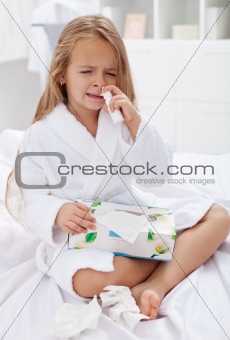 Little girl with a bad case of influenza using nasal spray