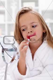 Little girl trying lipstick