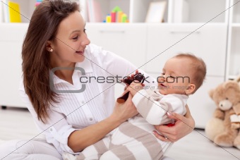 Young mother playing with her baby girl
