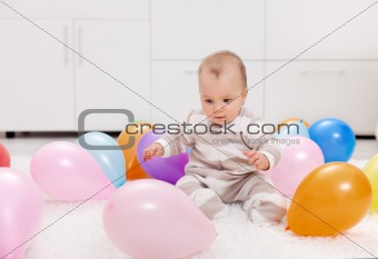 Baby girl with balloons