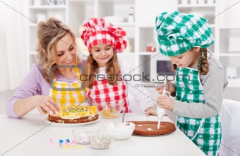 Woman and her daughters in the kitchen