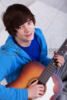 Happy teenager with guitar