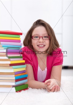 Young girl with lots of books