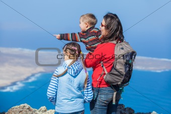 Mother and her child standing on cliff's edge
