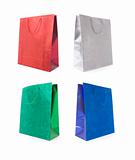 Set of Four Multicolored Glitter Gift Bags on a White Background.