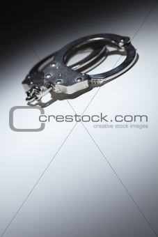 Abstract Pair of Handcuffs Under Spot Light With Room For Your Own Text.