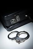 Pair of Handcuffs and Briefcase Under Spot Light Abstract.