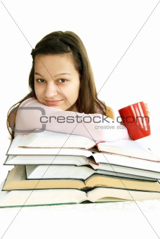 Happy teenage girl with books and tea