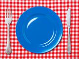Blue dinner plate with fork and knife 