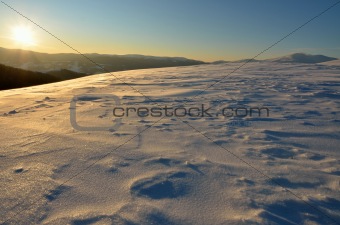 Beautiful winter sunset in snowy mountains