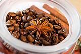 Star anise in an open jar of coffee beans