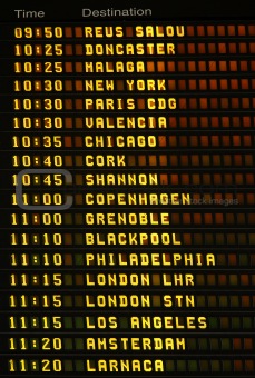 An electronic airport airplane departures board.