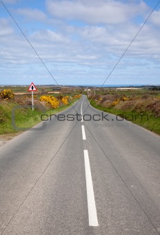 English country road with the sea on the horizon.