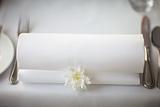 White folded napkin on a covered table