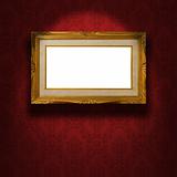 Empty golden frame on the wall.