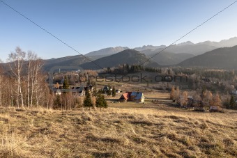 meadows and mountains and several houses