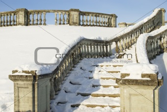 A snow-bound stone stair is in a winter park