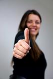 close up of young woman with thumb up smiling