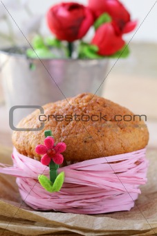 homemade cupcake are decorated with a pink ribbon