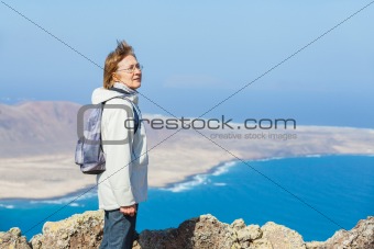 Portrait senior woman with backpack