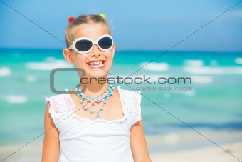 Adorable happy smiling girl on beach vacation