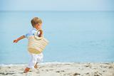 Boy with beach bag on tropical beach