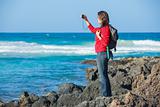 Young woman photographing a beautiful view