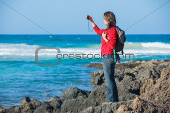 Young woman photographing a beautiful view