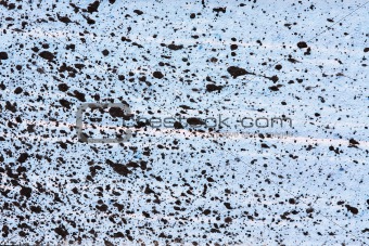 Black paint splatter on blue background