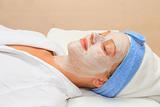 Young lady with facial mask in spa