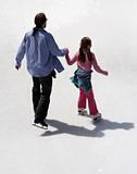 Father and daughter ice skating