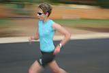 Female athlete running fast.